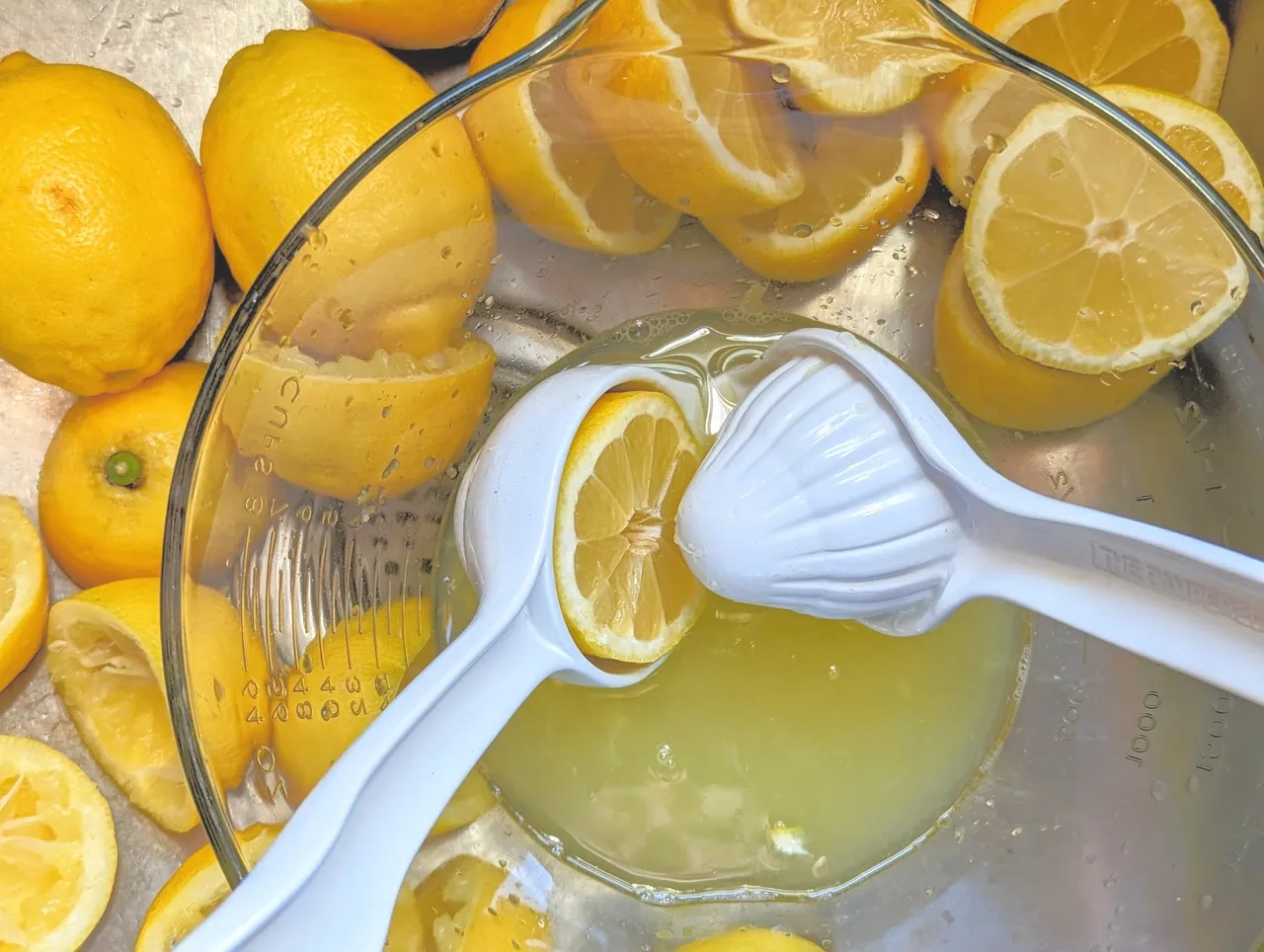 Lemons and juice in glass bowl