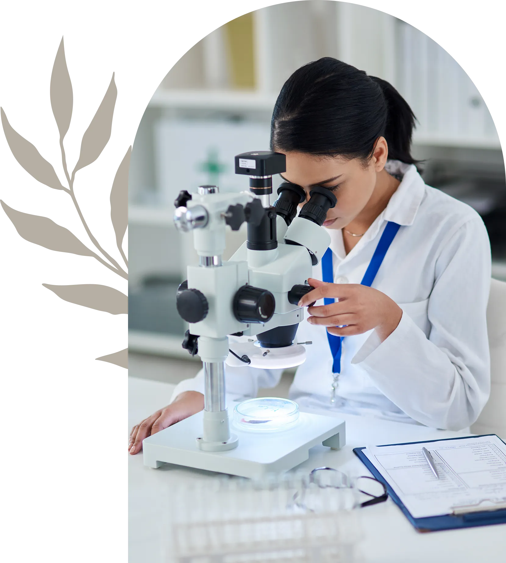 Woman in lab coat with microscope