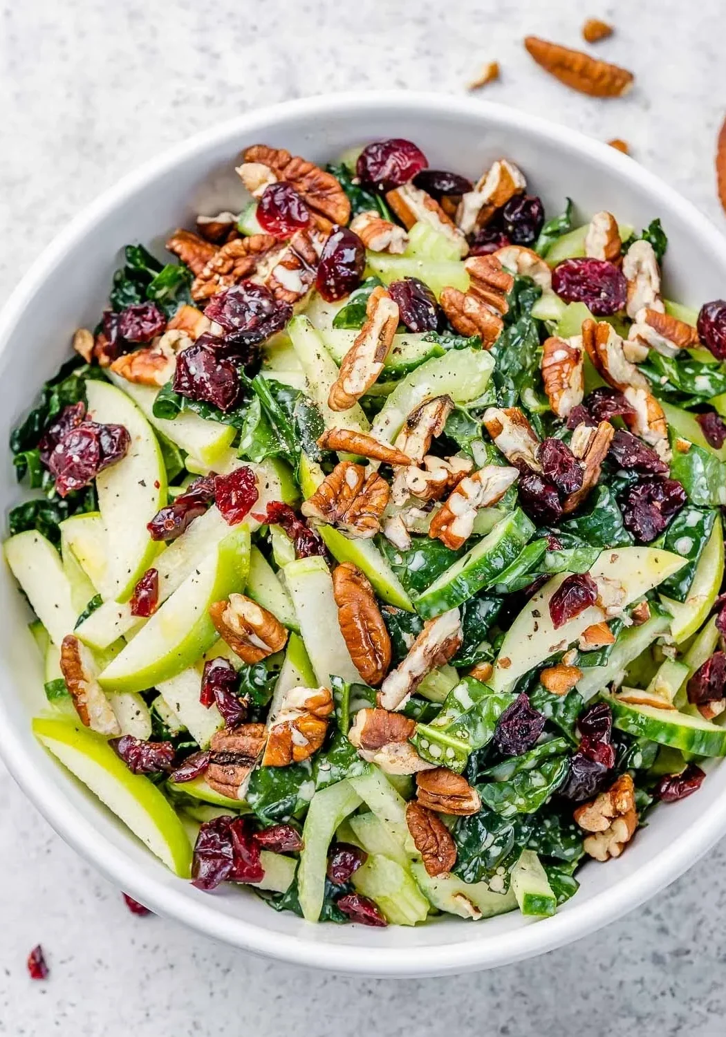 Healthy green salad with fruit and nuts