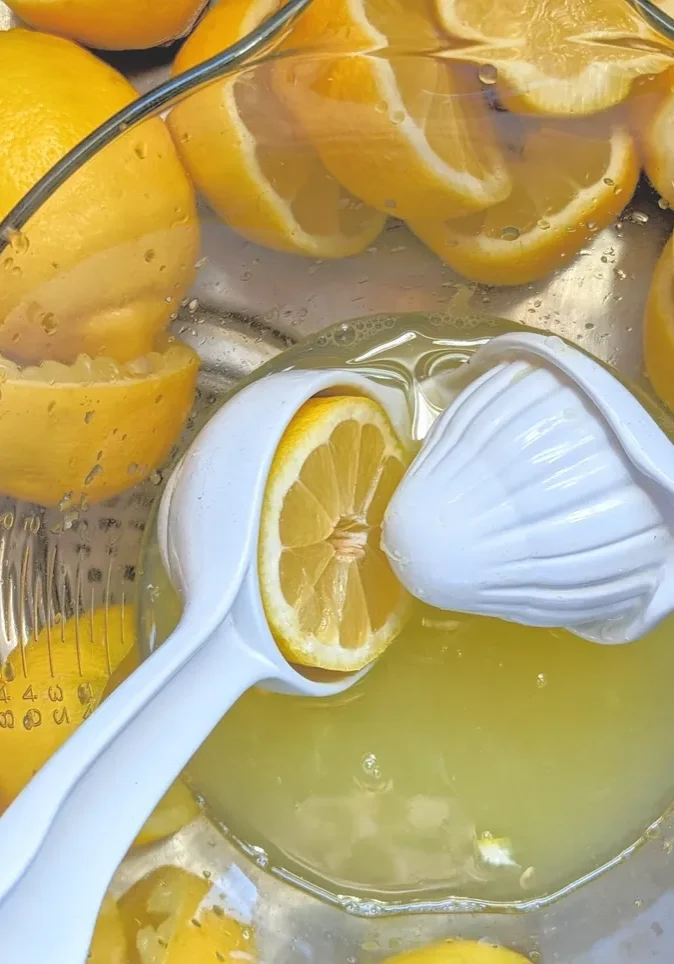 Lemons and juice in glass bowl